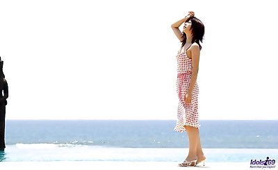 Young looking Japanese girl Saki Ninomiya gets naked with ocean behind her